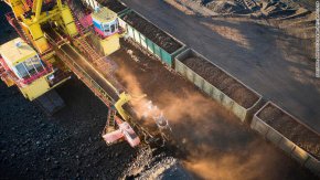 Работници товарят въглища във вагони на влак в мина в района на Красноярск, Сибир, Русия.