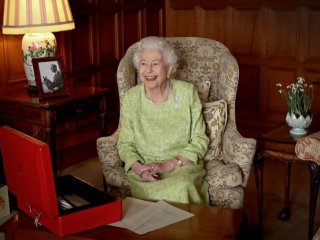 Кралицата работи над червените си кутии заедно със снимка на